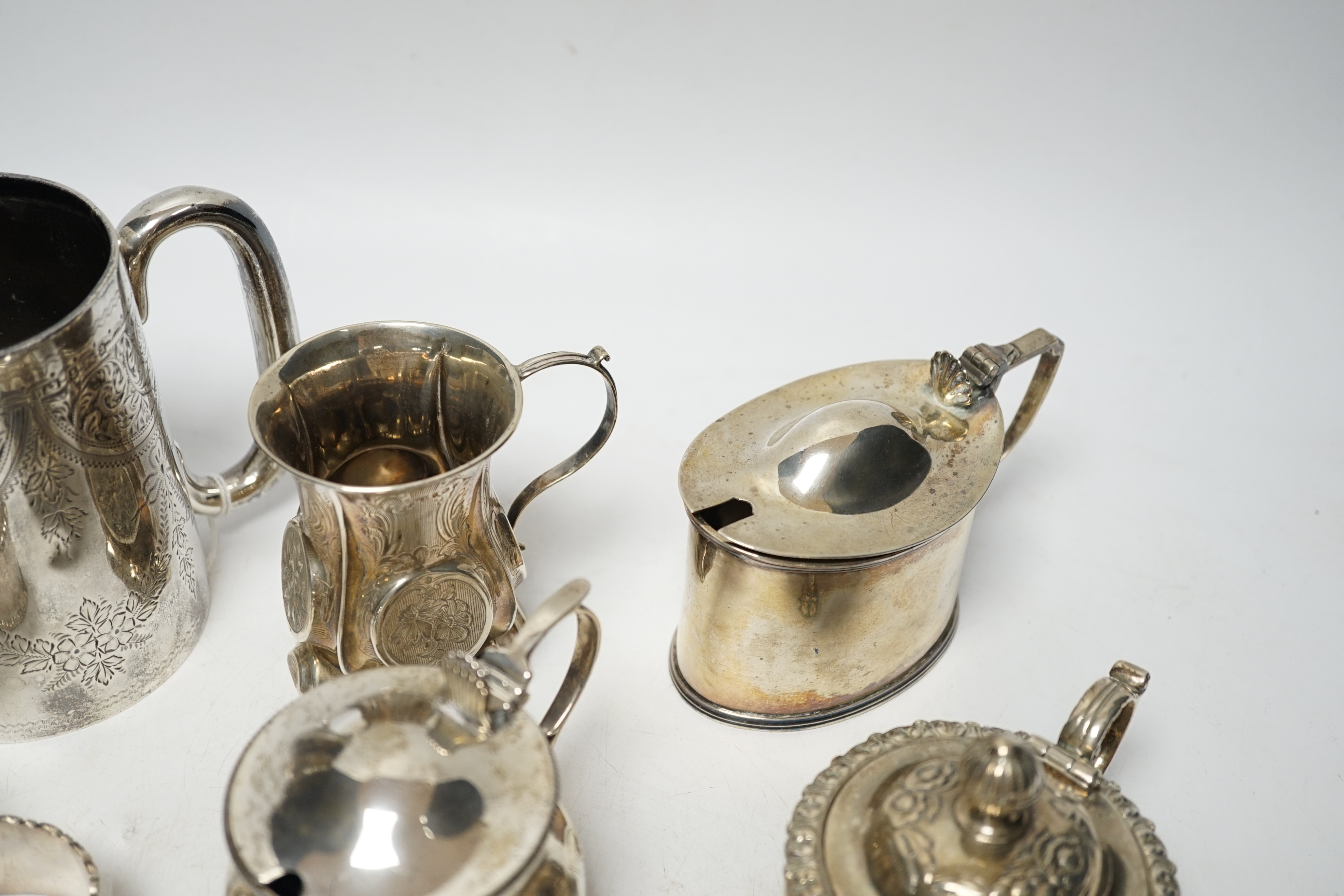 A late Victorian engraved silver mug, Hilliard & Thomason, Birmingham, 1900, 10.2cm, three assorted silver mustard pots including Victorian, a small Victorian silver christening mug and a set of six silver napkin rings,